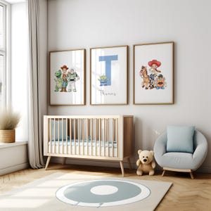 May include: Three framed prints featuring Toy Story characters and a blue letter "T" with the name "Thomas" in a nursery. The room includes a wooden cot, a grey armchair, a teddy bear, and a rug with a blue circle design.