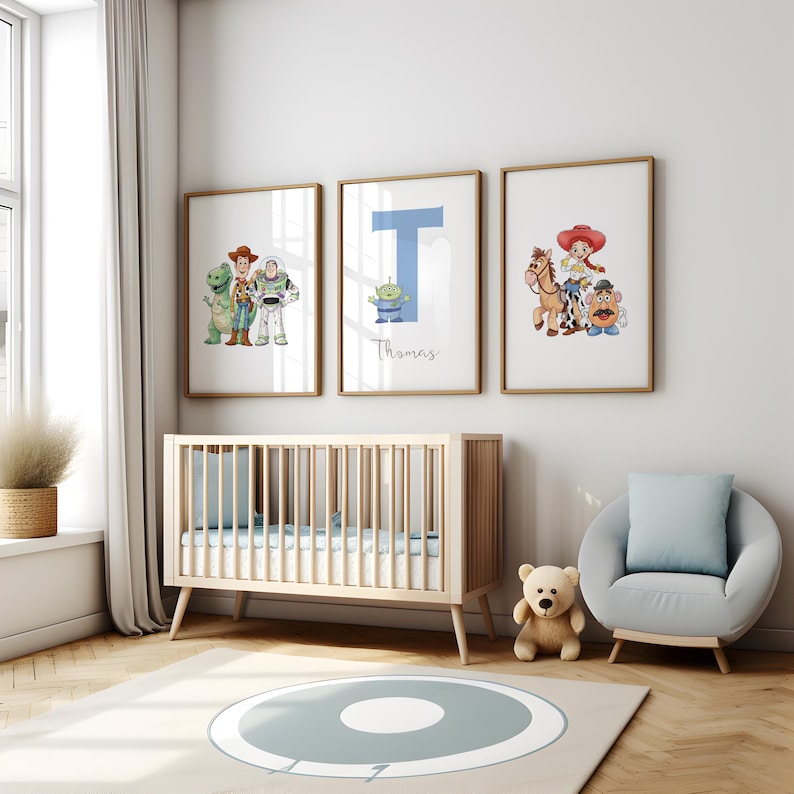 May include: Three framed prints featuring Toy Story characters and a blue letter "T" with the name "Thomas" in a nursery. The room includes a wooden cot, a grey armchair, a teddy bear, and a rug with a blue circle design.
