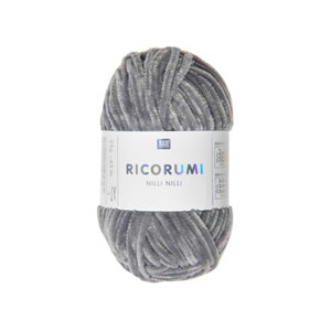 May include: A ball of grey yarn with a soft, velvety texture. The label reads "RICORUMI NILLI NILLI" and includes measurements of 25g - 65 m. Suitable for knitting and crochet projects.
