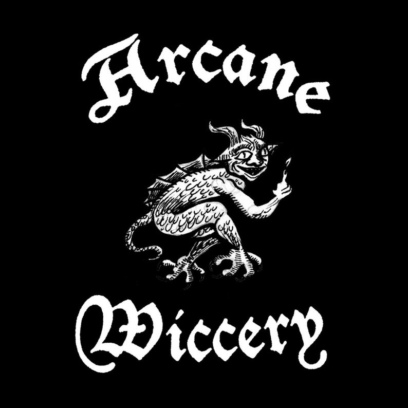 May include: Black and white illustration of a cartoon demon with the words "Arcane Wiccery" in a gothic font.