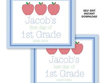 May include: Two blue-framed signs with text and apple graphics. One sign reads "Jacob's first day of 1st Grade 2023-2024" and the other reads "Jacob's last day of 1st Grade 2023-2024". The signs have red gingham apple illustrations.