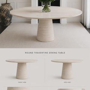 May include: A round travertine dining table with a light beige finish. The table has a circular top and a cylindrical base. The image also shows a vase of white roses and a large decorative vase. The table is approximately 152 cm in diameter.