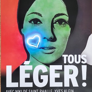 May include: A poster advertising an art exhibition titled "Tous Leger!" featuring works by Niki de Saint Phalle, Yves Klein, Martial Raysse, and Keith Haring. The poster features a close-up of a woman's face with a neon blue heart over her mouth. The poster is red, green, and black.
