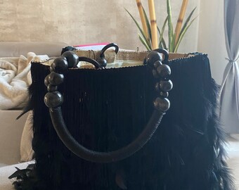 Jute bag with personalized handles, hand-sewn silk fringes and black feathers, fully lined interior with two roomy pockets