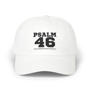 May include: White baseball cap with the text "PSALM 46" in black block letters. Below the number 46, the text reads "GOD IS OUR REFUGE AND STRENGTH."