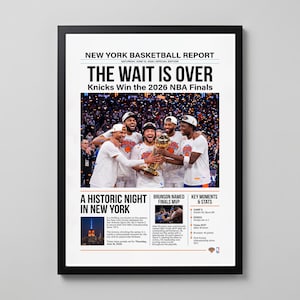 May include: A framed newspaper-style print titled New York Basketball Report, featuring the headline The Wait Is Over, Knicks Win the 2026 NBA Finals. It shows a photo of basketball players holding a trophy, with text detailing the historic victory.