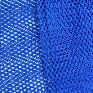May include: Close-up of a bright blue mesh fabric with a diamond pattern. The fabric is woven with a tight weave and has a smooth texture.
