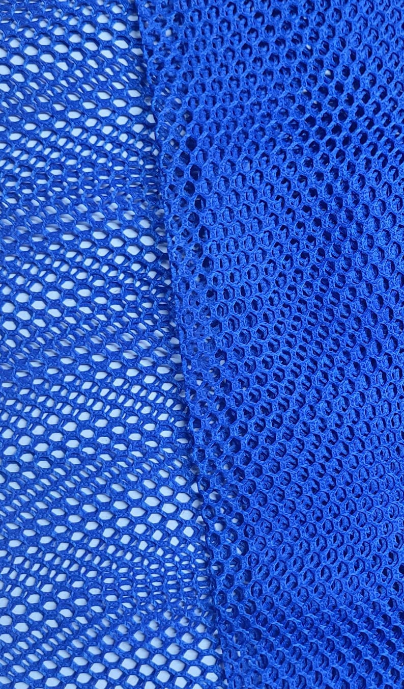 May include: Close-up of a bright blue mesh fabric with a diamond pattern. The fabric is woven with a tight weave and has a smooth texture.