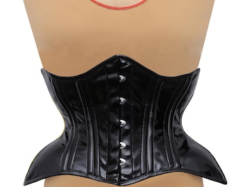 May include: A black patent leather corset with a yellow trim and silver metal busk closures. The corset has a classic design with a pointed waist and a wide, flared skirt. The corset is displayed on a mannequin.