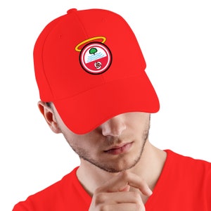 May include: A red baseball cap with a white and red embroidered logo. The logo features a tree, a river, and a halo.