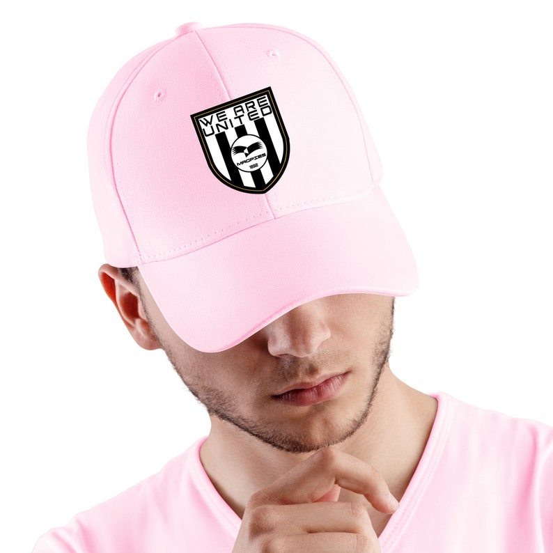 May include: A pink baseball cap with a black and white logo that says "We Are United" and has a black eagle with the words "Warriors 2009" underneath.