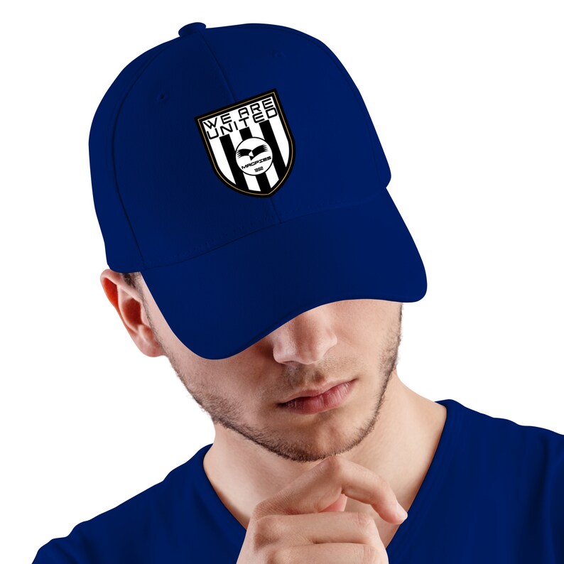 May include: A navy blue baseball cap with a black and white logo featuring a bird and the text "WE ARE UNITED" in gold lettering.