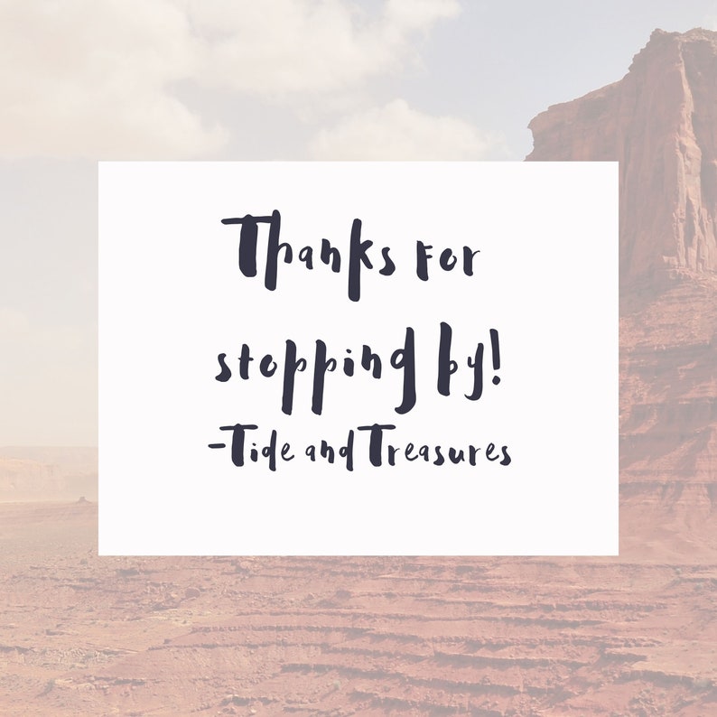 May include: White card with black handwritten text that says "Thanks for stopping by! - Tide and Treasures" against a blurred background of a red rock formation.
