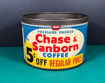 May include: A blue and yellow vintage coffee can with the text "Chase & Sanborn Coffee" and "5¢ off regular price" printed on it.