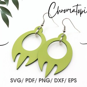 May include: A pair of green earrings with a unique design. The earrings are shaped like a crescent moon with a circle in the center. The earrings are made of a lightweight material and have a silver hook.