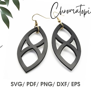 May include: A pair of black leather earrings with a geometric design. The earrings are shaped like a leaf and have a cutout pattern. The earrings are hanging from gold hooks.