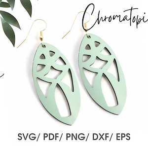 May include: A pair of light green, oval-shaped earrings with a delicate, intricate cut-out design. The earrings have gold hooks.
