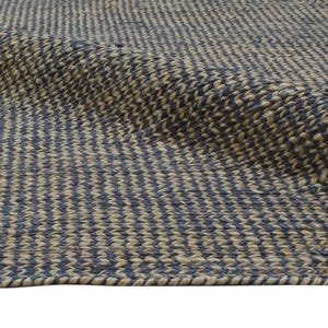 Puede incluir: Primer plano de una alfombra tejida con un patr&oacute;n repetitivo de rayas verticales azules y beige alternas. La alfombra tiene una superficie texturizada y un borde enrollado, lo que sugiere un material de fibra natural.