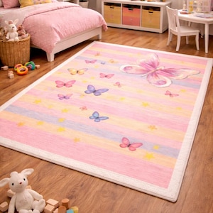 May include: A rectangular children's rug with a pink, yellow, and blue striped pattern. The rug features butterfly and star designs. A large butterfly is in the upper right corner. The rug has a white border.