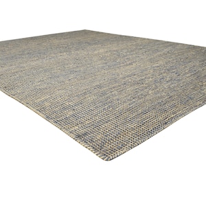 Puede incluir: Una alfombra rectangular con textura tejida, en tonos azules y beige. El patr&oacute;n de tejido es visible, agregando profundidad. Esta cubierta de suelo se integrar&aacute; en varios estilos de interior.