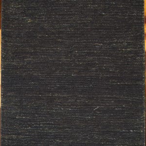 May include: A rectangular, dark charcoal-colored rug with a textured surface. The rug's fibers create a subtle, horizontal pattern. The rug is likely made of natural fibers, suitable for home decor.