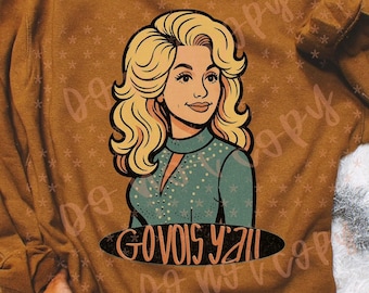 May include: Mustard-colored sweatshirt featuring a cartoon illustration of a woman with blonde hair and a teal top. The text "GO VOIS Y'ALL" is printed below the illustration in a black oval.