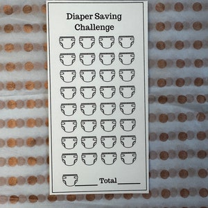 May include: A black and white printable diaper saving challenge chart with 30 diaper icons and a space to write in the total number of diapers saved. The chart has the text "Diaper Saving Challenge" at the top.