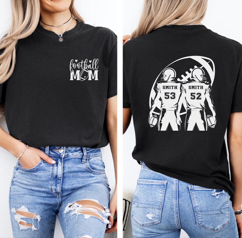 May include: Black t-shirt with "football MOM" text and a football graphic on the front. The back of the shirt features two football players with the name "Smith" and numbers 53 and 52. The shirt is made of a soft material.