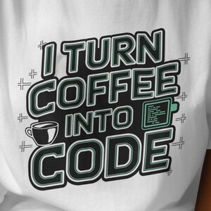 May include: White t-shirt with a black and green graphic that says "I turn coffee into code".