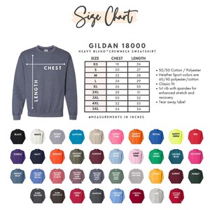 May include: A size chart for Gildan 18000 heavy blend crewneck sweatshirts. The chart shows chest and length measurements in inches for sizes XS to 5XL. The chart also includes information about the fabric composition and fit.