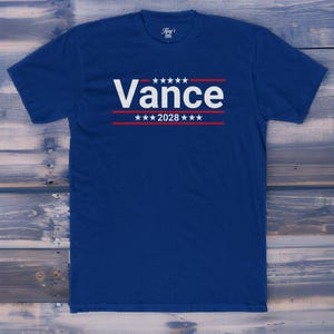 May include: A royal blue t-shirt with a white graphic that says "Vance" with stars and red stripes above and below the name. The text "2028" is below the name.