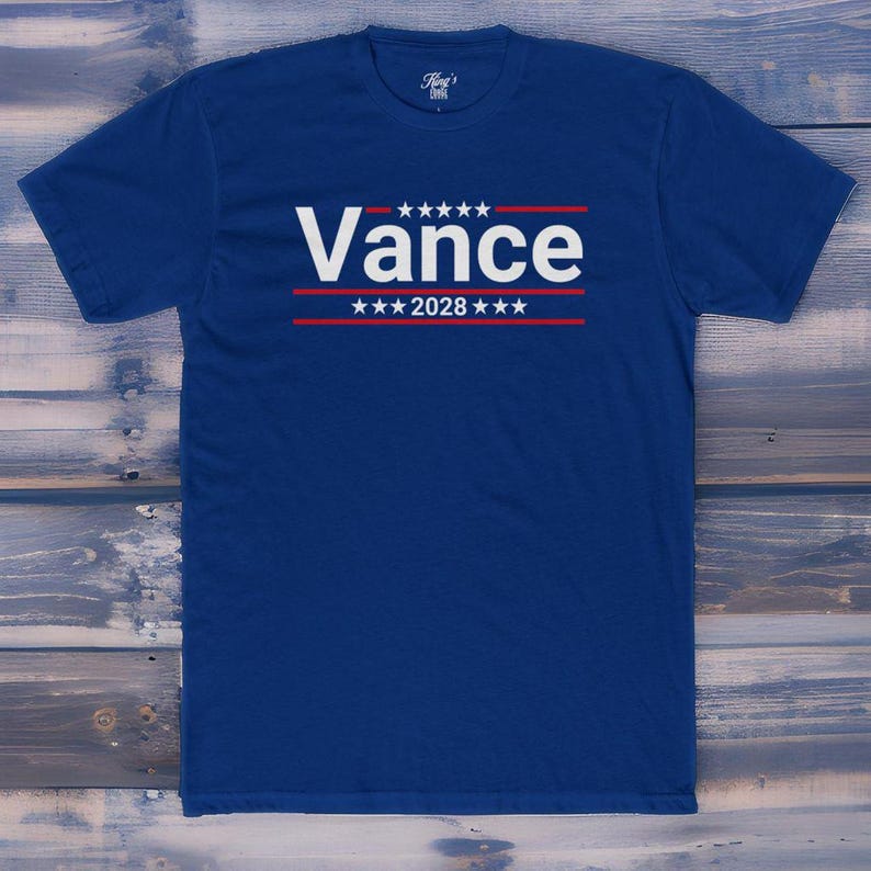 May include: A royal blue t-shirt with a white graphic that says "Vance" with stars and red stripes above and below the name. The text "2028" is below the name.
