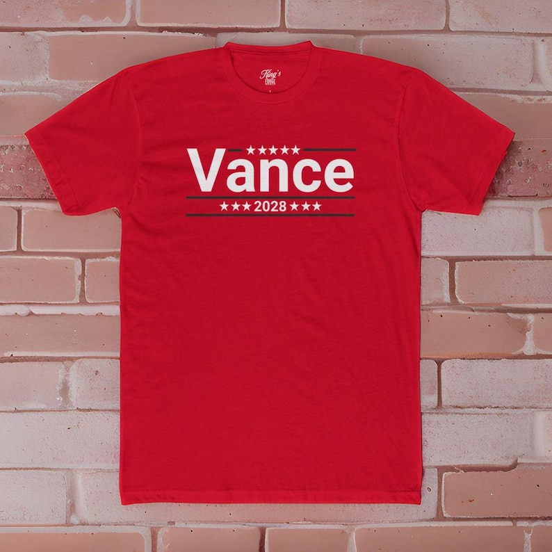 May include: Red t-shirt with white text that says "Vance 2028" with stars above and below the text.
