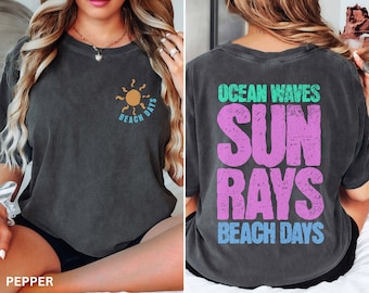 May include: A black t-shirt with a sun graphic and the text "Beach Days" on the front and the text "Ocean Waves Sun Rays Beach Days" on the back.