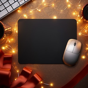 May include: A black computer mouse pad with a silver wireless mouse on top. The mouse pad is surrounded by string lights and red ribbon.