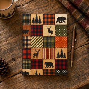 May include: A rectangular notebook featuring a patchwork grid design with alternating squares of red, green, and black plaid, polka dots, and stripes. The squares contain black silhouettes of bears, deer, and pine trees on a tan background.