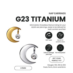 May include: Gold and silver moon-shaped earrings with a dangling clear gem. The earrings are made of G23 titanium and are threadless. The image includes text that says "NAP EARRINGS" and "G23 TITANIUM". The earrings are 4.5mm in size.