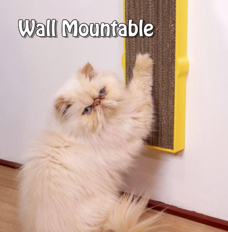 May include: A fluffy, cream-colored cat with blue eyes interacts with a wall-mounted cat scratcher. The scratcher is yellow with a brown, corrugated scratching surface. Text on the image reads "Wall Mountable".