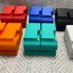 May include: Six pairs of stacked plastic storage containers in various colors, including red, orange, blue, turquoise, black, and white.