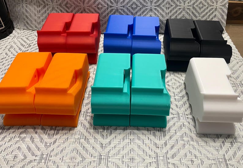 May include: Six pairs of stacked plastic storage containers in various colors, including red, orange, blue, turquoise, black, and white.