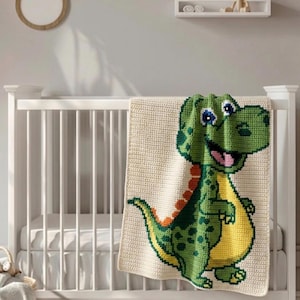 May include: A cream-colored, crocheted baby blanket featuring a green dinosaur design with yellow and orange accents. The dinosaur has blue eyes and a pink tongue. The blanket is draped over a white crib.