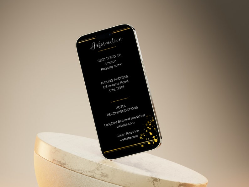 May include: A black smartphone with a gold border displays information about a wedding. The text includes the words "Information", "Registered At", "Amazon", "Registry name", "Mailing Address", "Hotel Recommendations", "Ladybird Bed and Breakfast", "website.com", "Green Pines Inn", and "webiste.com".
