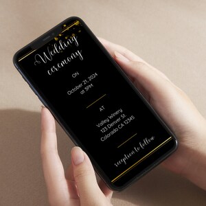 May include: A black smartphone screen displays a wedding ceremony invitation with gold accents. The invitation includes the date, time, location, and the text "reception to follow".