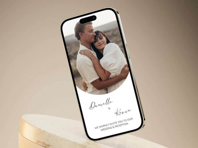 May include: A digital wedding invitation with a photo of a couple embracing. The invitation features a white background with black text that reads "Danielle x Kevin" and "We warmly invite you to our wedding & reception".
