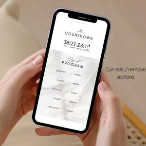 May include: A smartphone screen shows a wedding countdown and schedule. The display reads "The Countdown" with a timer, and "Day of Program" with ceremony, photos, cocktails, dinner, and ever after times. The phone is held in two hands.