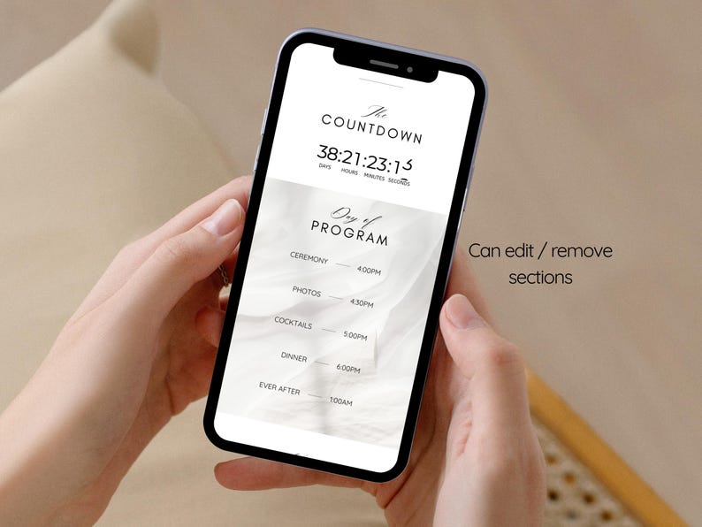 May include: A smartphone screen shows a wedding countdown and schedule. The display reads "The Countdown" with a timer, and "Day of Program" with ceremony, photos, cocktails, dinner, and ever after times. The phone is held in two hands.