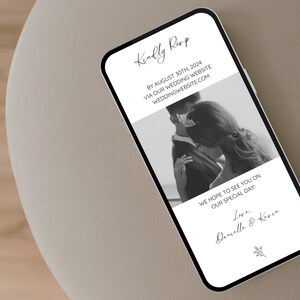 May include: A black and white photograph of a couple on their wedding day. The text on the phone screen reads "Kindly RSVP by August 30th, 2024 via our wedding website weddingwebsite.com. We hope to see you on our special day! Love, Danielle & Keren."