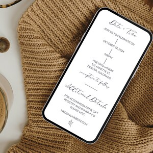 May include: A white smartphone mockup displaying a wedding invitation on the screen. The invitation has a simple design with black text and a line down the centre. The text reads "Date & Time", "Join us to celebrate on", "October 22, 2024", "5:00PM", "Vineyard Winery", "123 Annette St.", "Denver, Colorado", "Reception to follow", "Additional Details", "For accommodations, gift registry and other info please visit: weddingwebsite.com".