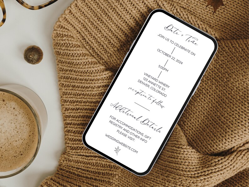 May include: A white smartphone mockup displaying a wedding invitation on the screen. The invitation has a simple design with black text and a line down the centre. The text reads "Date & Time", "Join us to celebrate on", "October 22, 2024", "5:00PM", "Vineyard Winery", "123 Annette St.", "Denver, Colorado", "Reception to follow", "Additional Details", "For accommodations, gift registry and other info please visit: weddingwebsite.com".