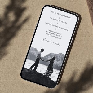 May include: A black and white photo of a couple holding hands on a beach. The invitation is for a wedding reception on September 20th, 2025 at 4:00 PM at Liberty Gardens, 123 Annette Street, Denver, Colorado. Reception to follow.